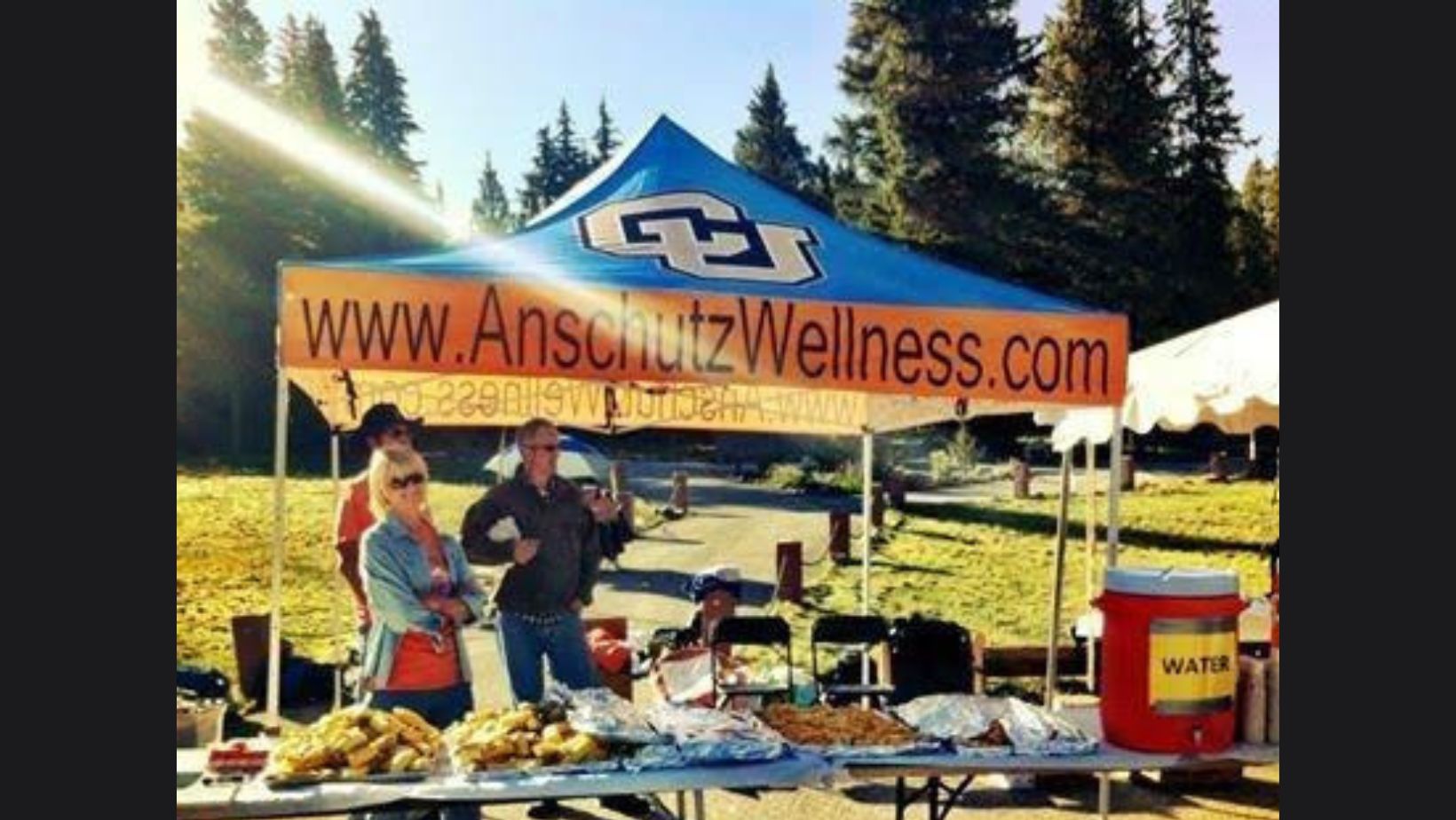 Picture showing Anschutz Wellness custom logo 10x10 tent at a picnic